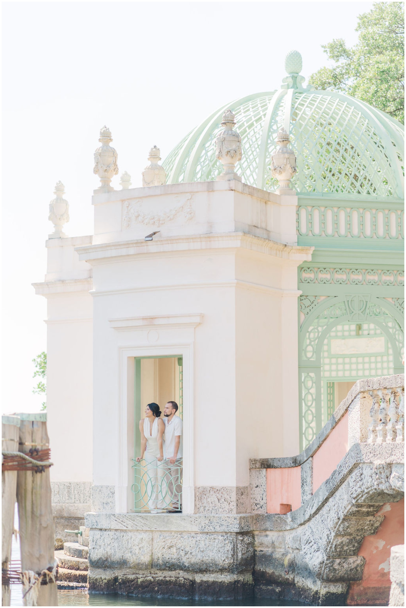 Newlyweds look out the window of a waterfront gazebo at one of the luxurious wedding venues in Miami