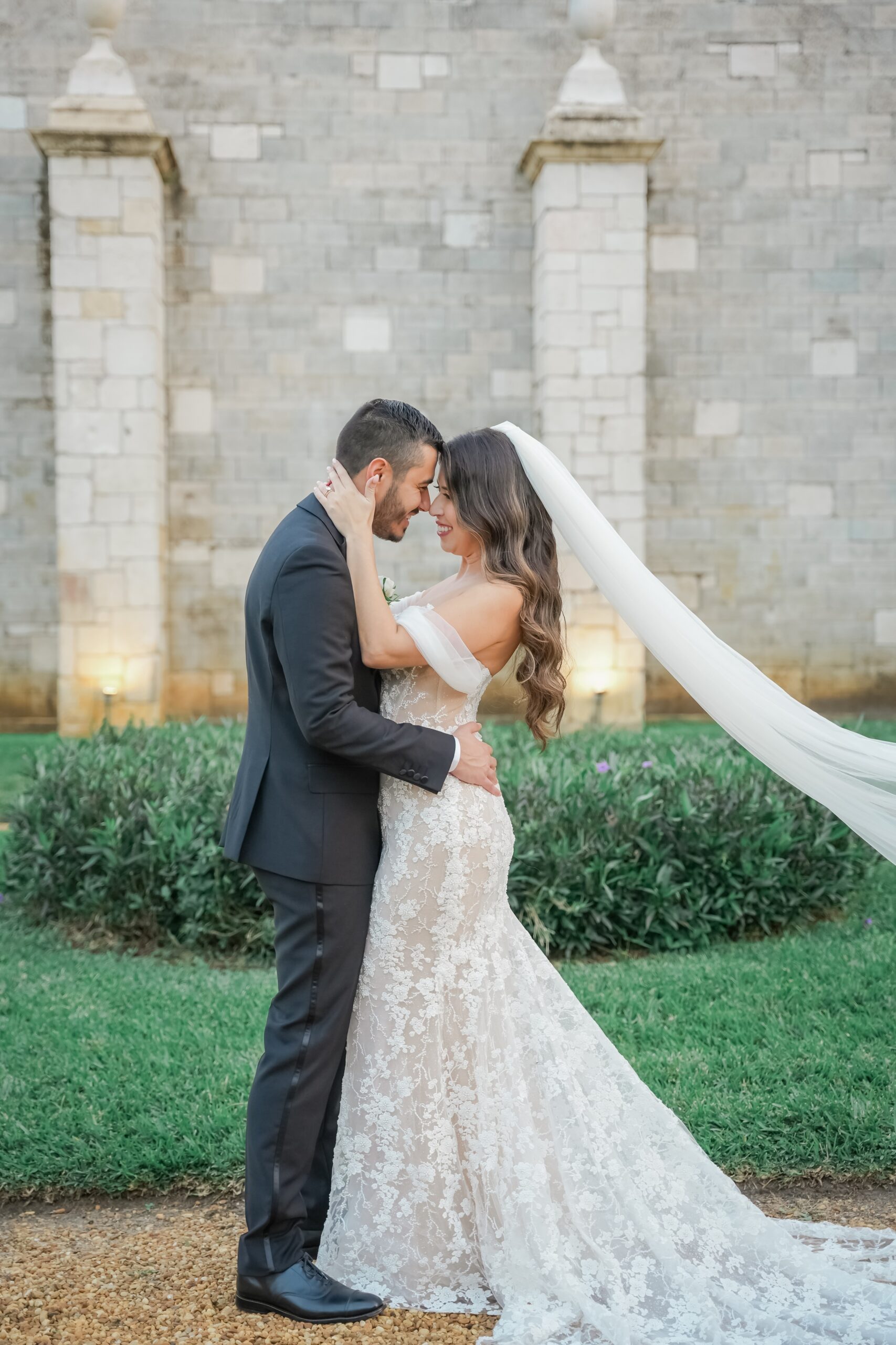 Newlyweds share a happy snuggle in the gardens