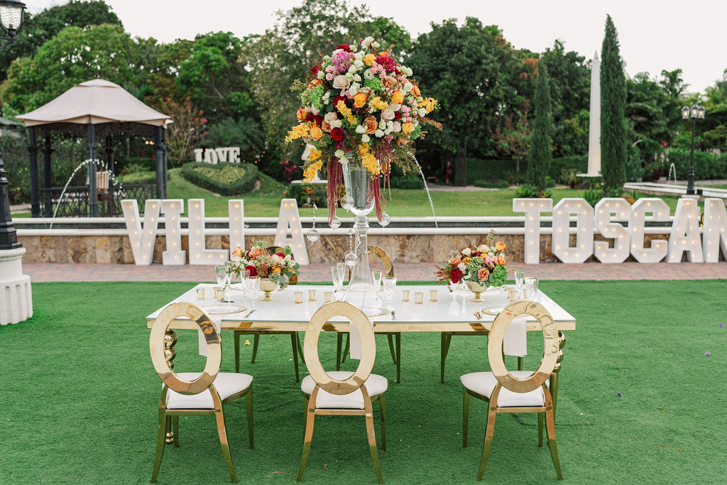 A wedding reception table set up in a garden at Villa Toscana