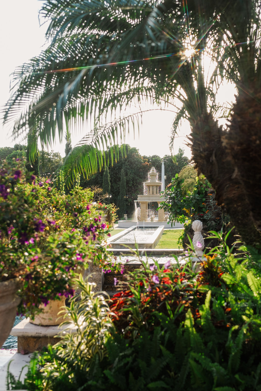 A look into a large garden with ponds and fountains